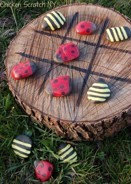 Use A Tree Stump And Some Stones To Create A Tic-Tac-Toe Game Board. 